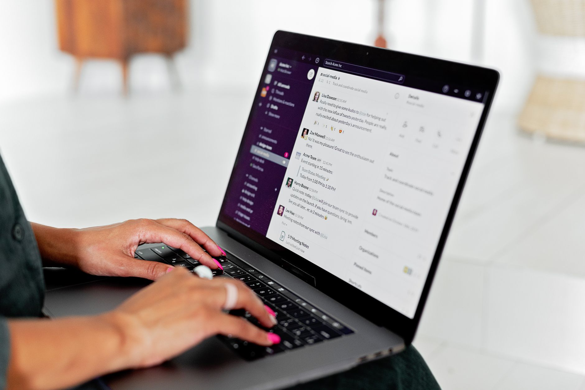 a freelancer typing an email template on a laptop at a cluttered desk