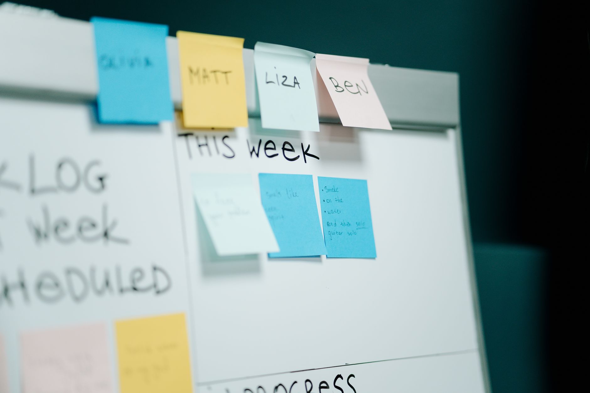 A freelancer mapping invoice automation fields on a whiteboard with sticky notes